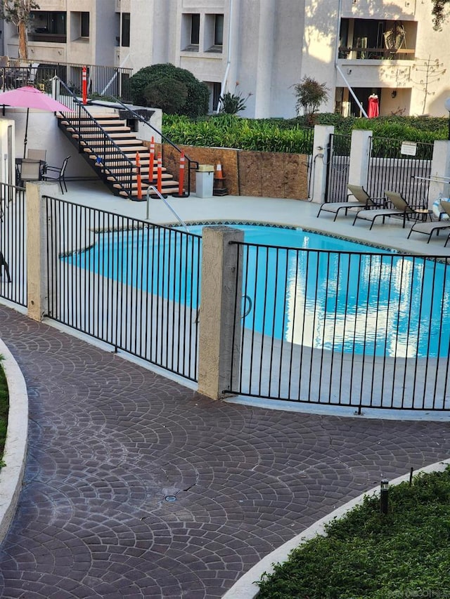 view of swimming pool featuring a patio area