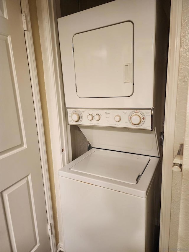 washroom with stacked washer / dryer