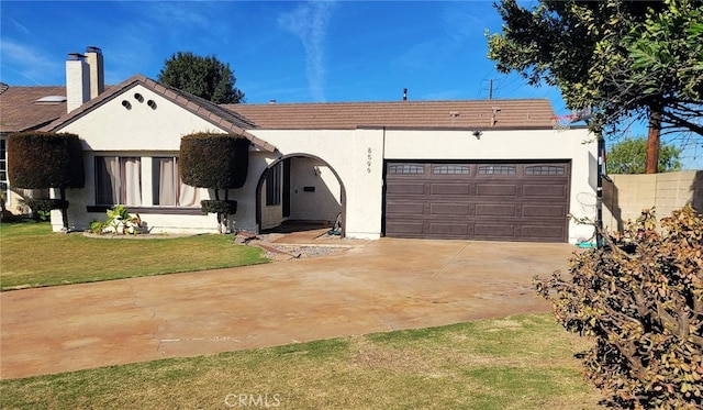 single story home featuring a front lawn and a garage