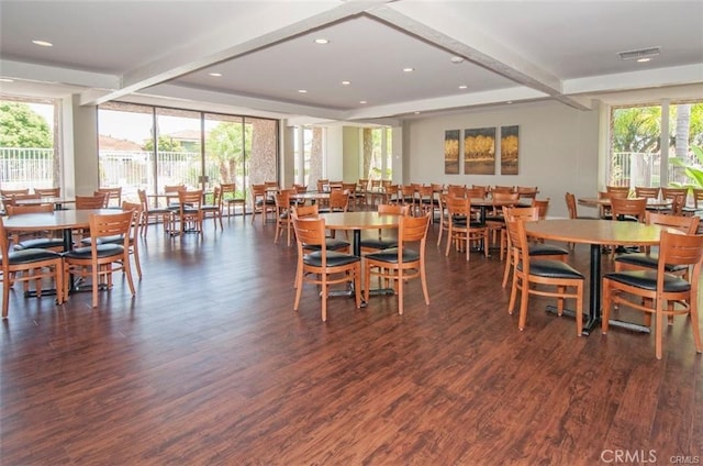 dining room with a healthy amount of sunlight, dark wood-type flooring, beamed ceiling, and floor to ceiling windows