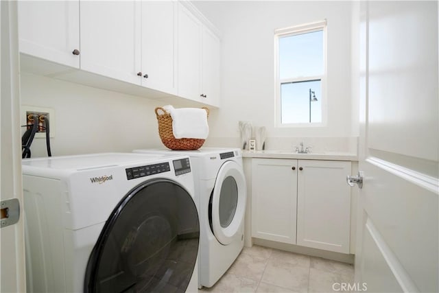 washroom with cabinets, light tile patterned flooring, and separate washer and dryer