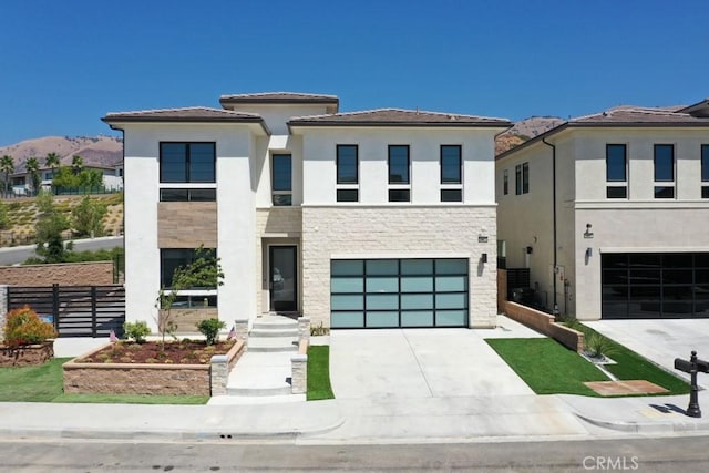 view of front of property featuring a garage and a mountain view