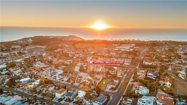 aerial view at dusk with a water view