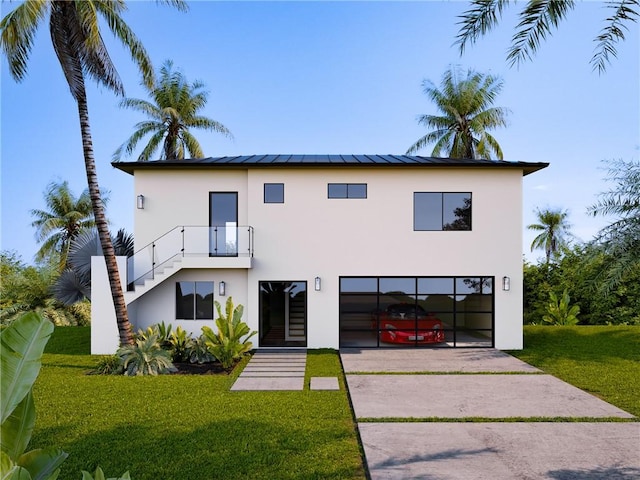 rear view of house with a garage and a yard