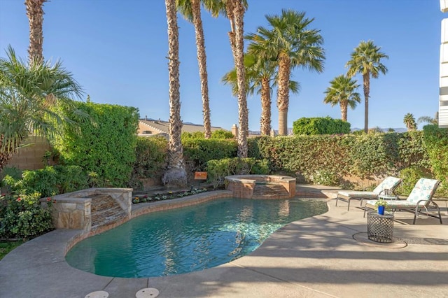 view of swimming pool featuring a patio area and an in ground hot tub