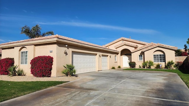 mediterranean / spanish-style house featuring a garage