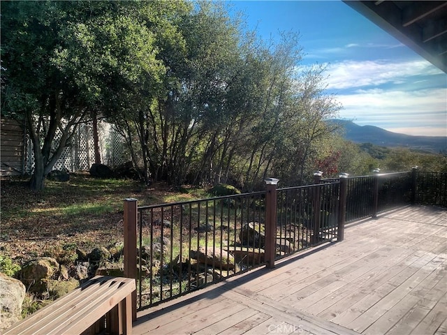 wooden deck featuring a mountain view