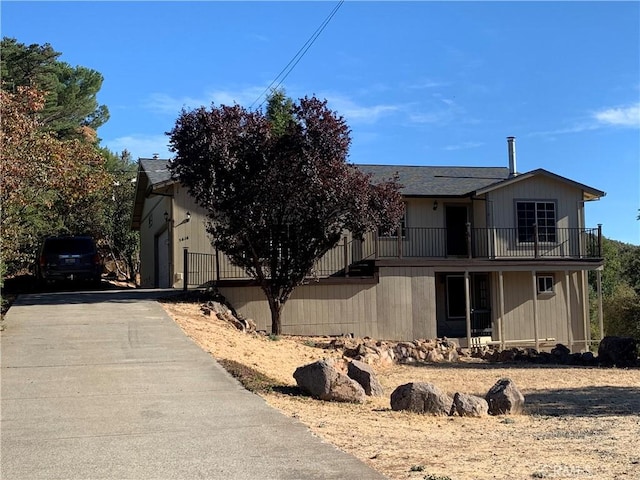 view of front of property with a garage and a balcony