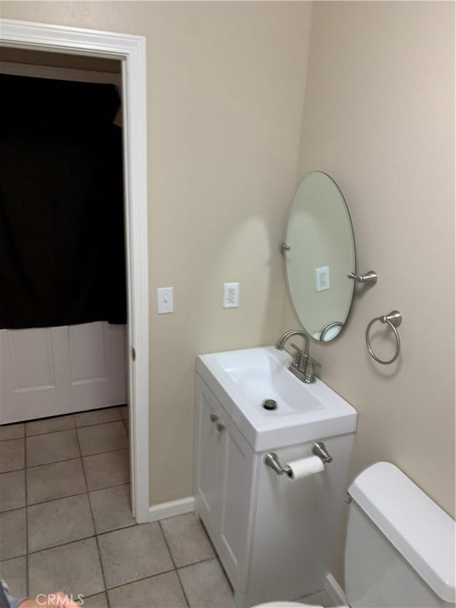 bathroom featuring tile patterned floors, toilet, and vanity