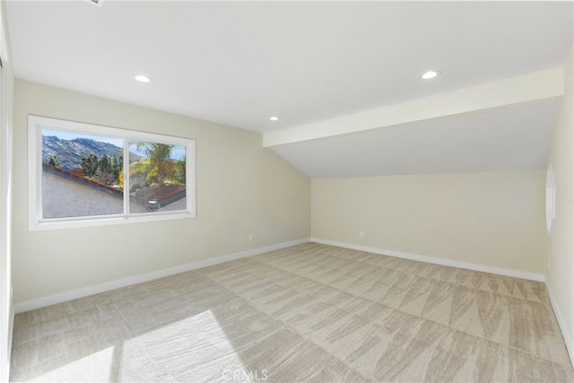 additional living space with vaulted ceiling and light colored carpet