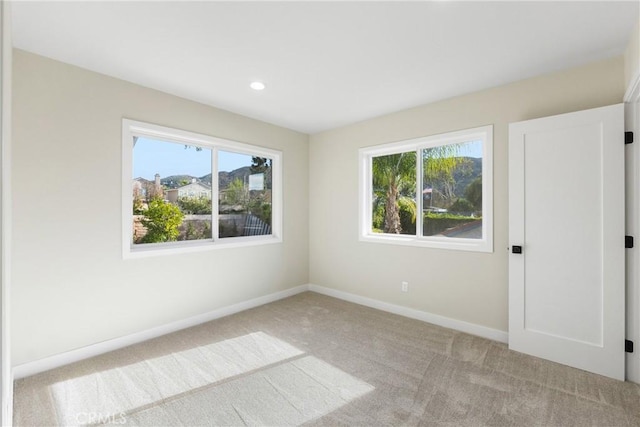 unfurnished room with light colored carpet