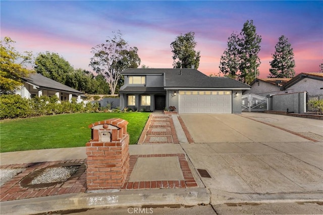 view of front facade featuring a garage and a yard