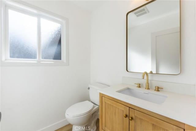 bathroom with toilet and vanity