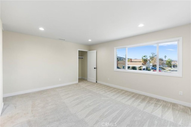 unfurnished room featuring light carpet