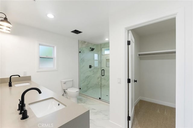 bathroom with walk in shower, vanity, and toilet