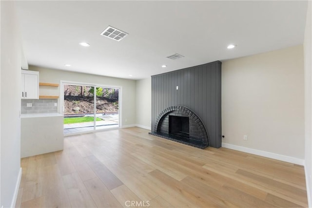 unfurnished living room with light hardwood / wood-style floors and a fireplace