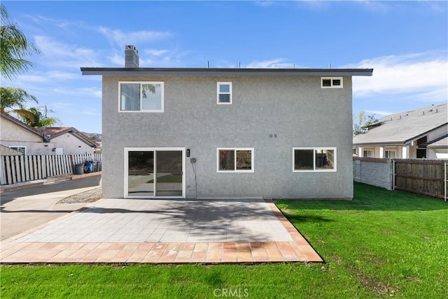 rear view of house with a yard and a patio