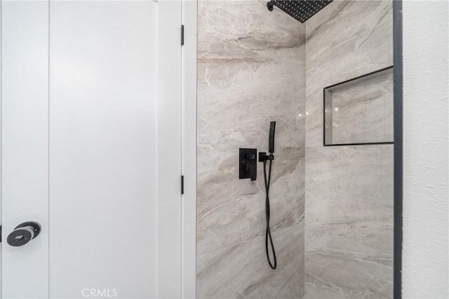 bathroom with a tile shower