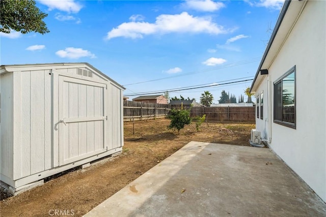 view of yard featuring a storage unit and a patio area