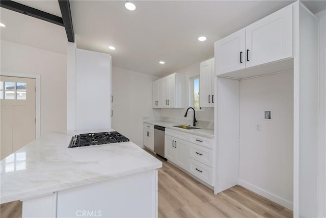 kitchen featuring light wood-type flooring, sink, stainless steel appliances, and white cabinetry