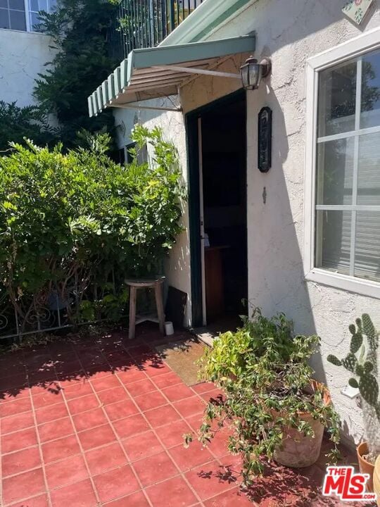 doorway to property with a patio area