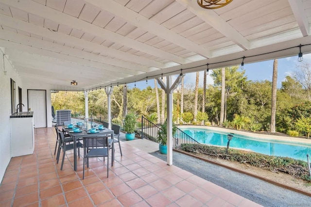 unfurnished sunroom featuring beam ceiling and wood ceiling