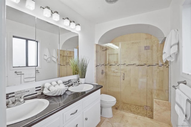 bathroom featuring toilet, an enclosed shower, vanity, and tasteful backsplash