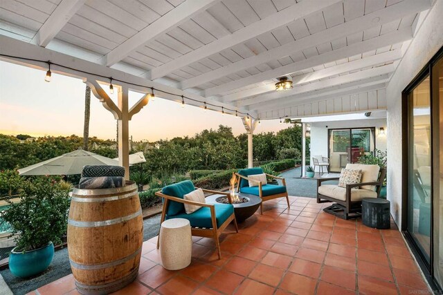 patio terrace at dusk featuring an outdoor living space