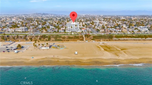 bird's eye view with a water view and a beach view