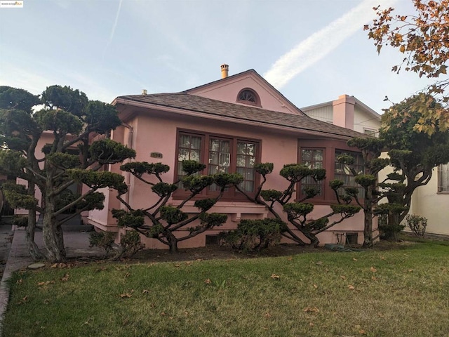 view of home's exterior with a lawn