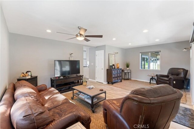 living room with ceiling fan and light hardwood / wood-style floors