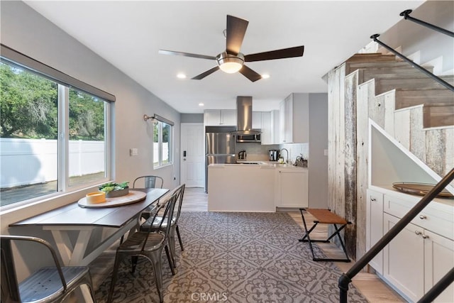 dining room featuring ceiling fan and sink