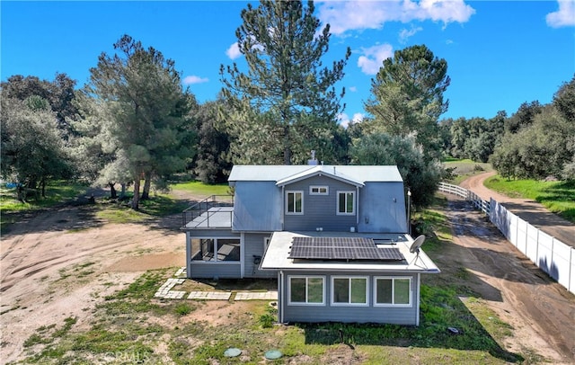 rear view of house with solar panels