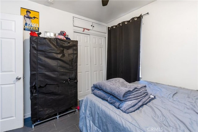 tiled bedroom featuring ceiling fan and a closet