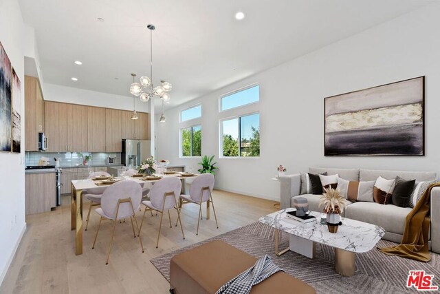 dining space featuring a chandelier and light hardwood / wood-style floors