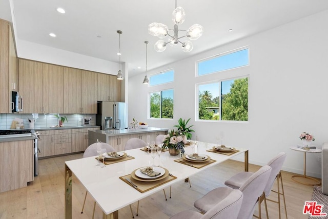 dining room with a chandelier and light hardwood / wood-style floors