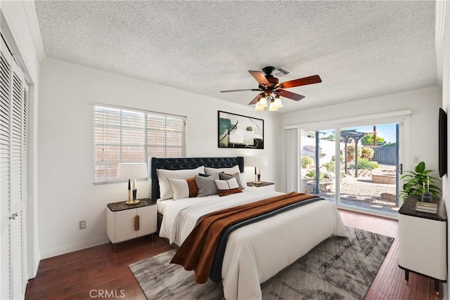 bedroom featuring access to outside, a closet, a textured ceiling, and ceiling fan