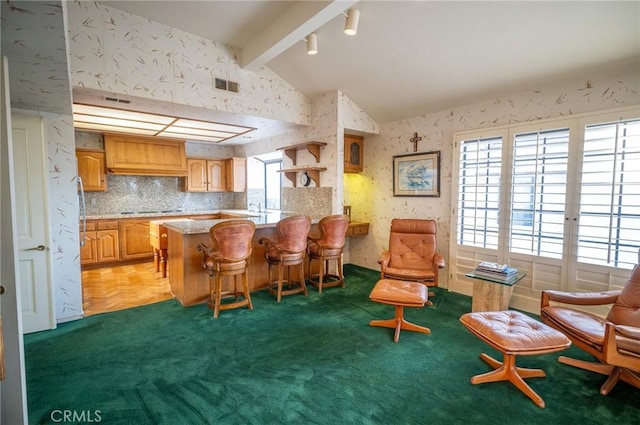 kitchen with carpet floors, vaulted ceiling with beams, kitchen peninsula, a breakfast bar area, and black electric cooktop