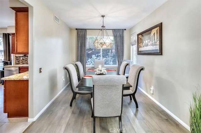 dining area featuring a healthy amount of sunlight and light hardwood / wood-style flooring