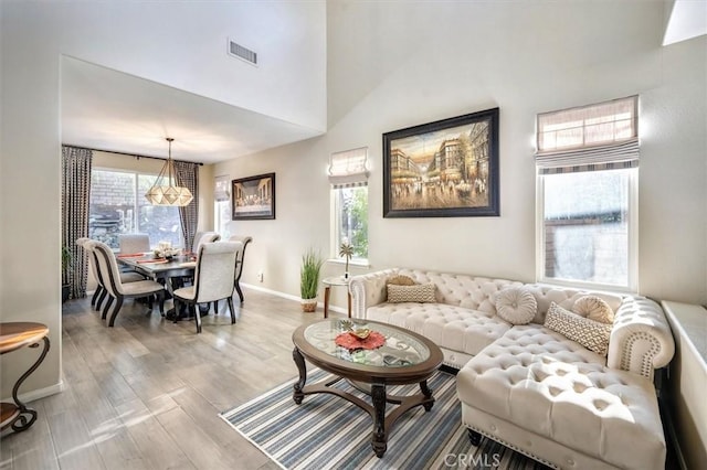 living room with light hardwood / wood-style flooring and a high ceiling