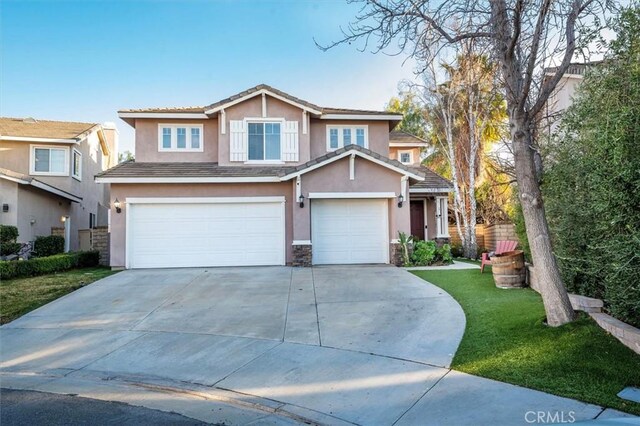 view of front of home featuring a garage and a front yard