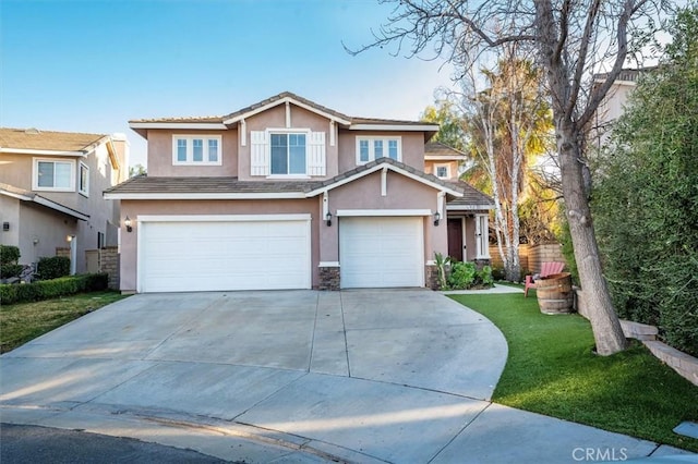 view of front of house featuring a garage and a front yard