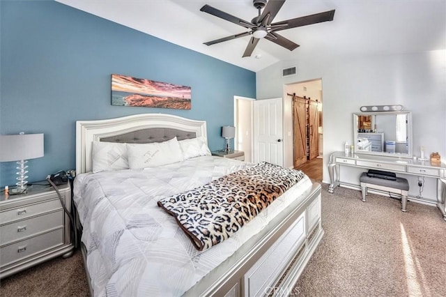 carpeted bedroom with lofted ceiling, ensuite bath, and ceiling fan