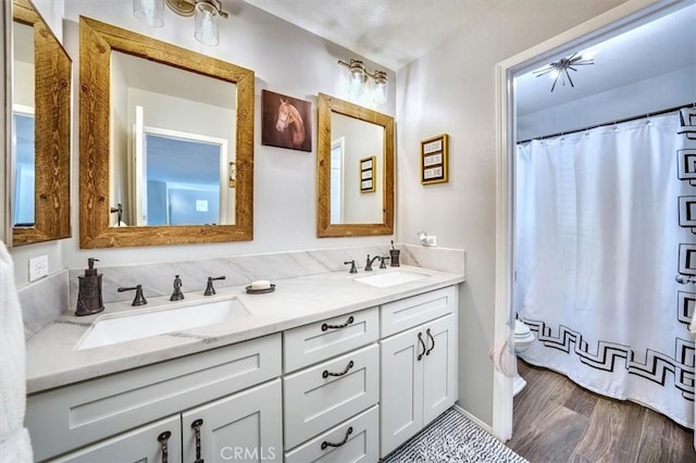 bathroom featuring vanity, hardwood / wood-style floors, and a shower with curtain