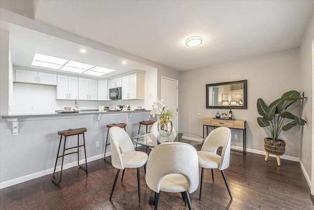 dining area featuring dark wood-type flooring