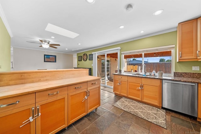 kitchen featuring a skylight, ceiling fan, ornamental molding, stainless steel dishwasher, and sink