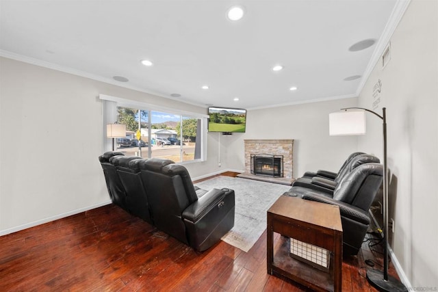 living room featuring wood-type flooring, ornamental molding, and a stone fireplace