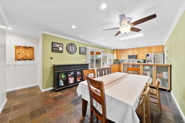 dining space featuring ceiling fan and crown molding