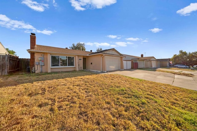 ranch-style house featuring a garage and a front yard