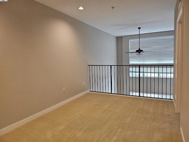 unfurnished room with ceiling fan and light colored carpet